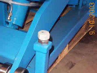 Baseframe of lift table showing adjustable downstops and arm roller bearings