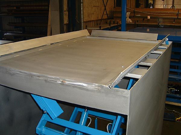 Scissor Lift Table with auto rising roll off protection and rigid steel skirts to prevent ingress into under sides
