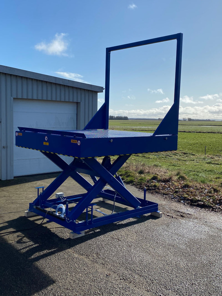 Scissor lift with fixed goal post barrier and auto-rising roll off stop (Section 1)