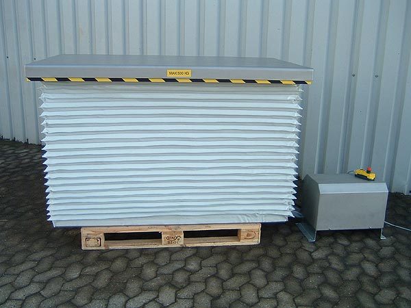 Stainless steel lift table complete with bellows guards and covered power pack (Section 1)
